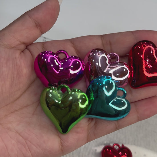 Size of heart pendants compared to hand