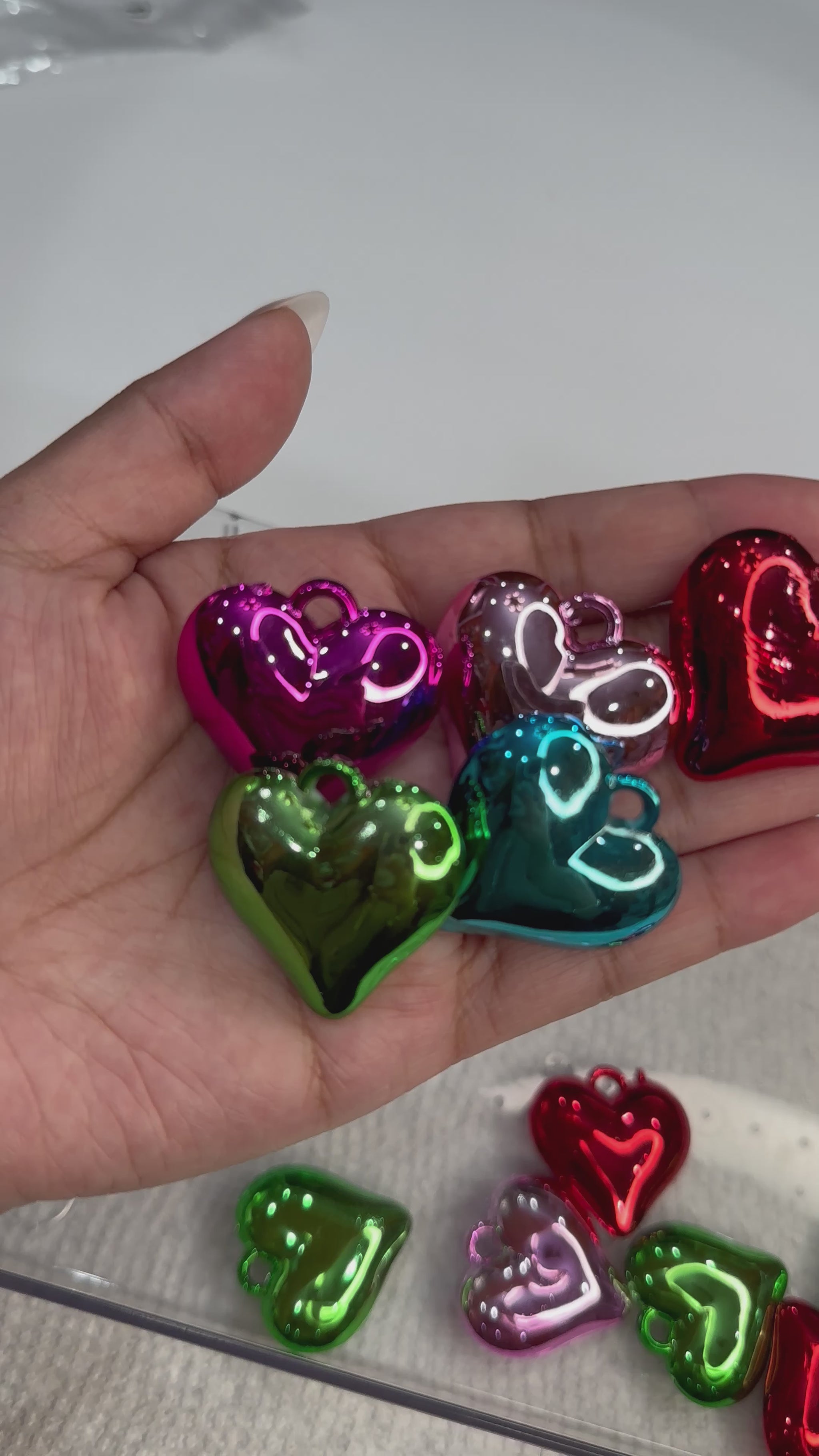 Size of heart pendants compared to hand